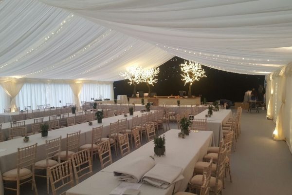 Christmas Party Marquee with starlight lighting to marquee top and fairy lit trees to bar area
