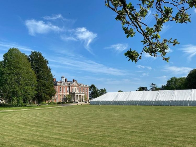 Hired marquee for Stansted House in Hampshire under blue sky