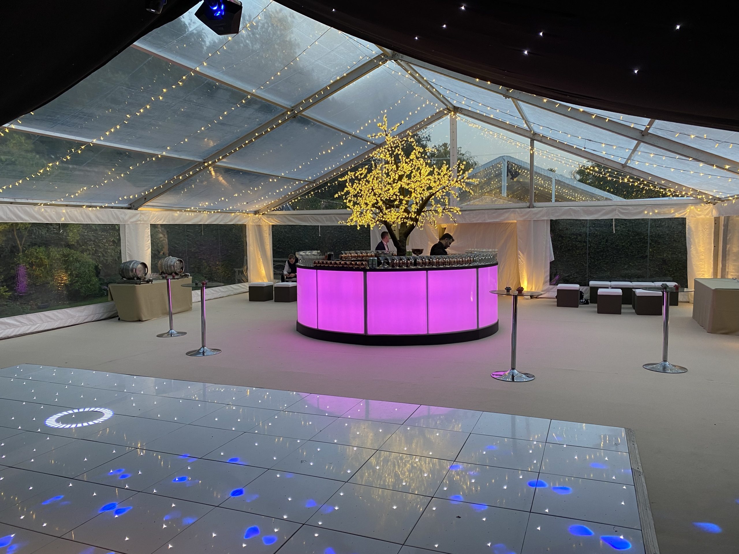 Starlit Bar and dance floor for parties with purple lighting around hired bar and fairy lit tree to centre of bar